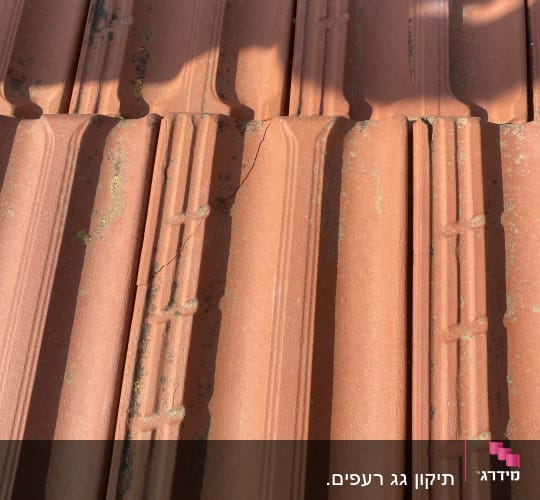 רעפים חומים עם סדקים וצללים על הגג